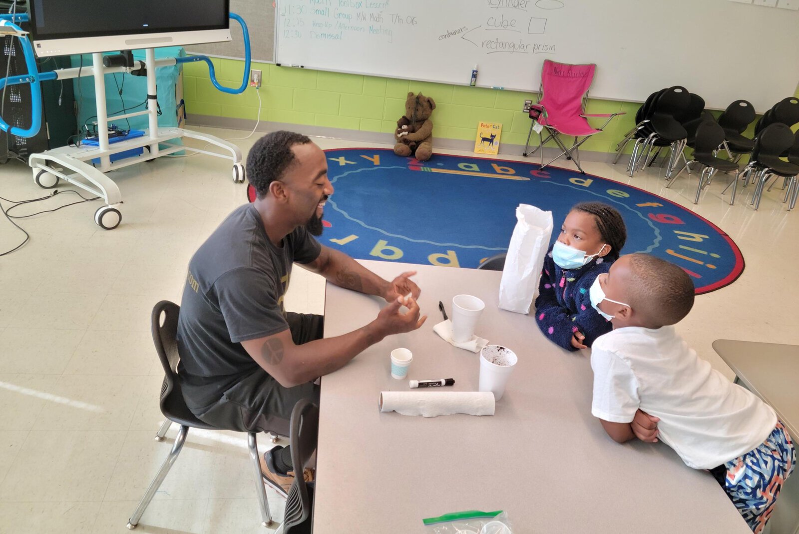 Kindergarten students planting their own classroom veggie seeds and learning how plants grow during their summer MyGarden lesson.