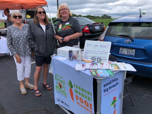 KISD Nutrition Educator Amy Klinkoski at the Kentwood Farmers Market at the Kent District Library's Kentwood branch.