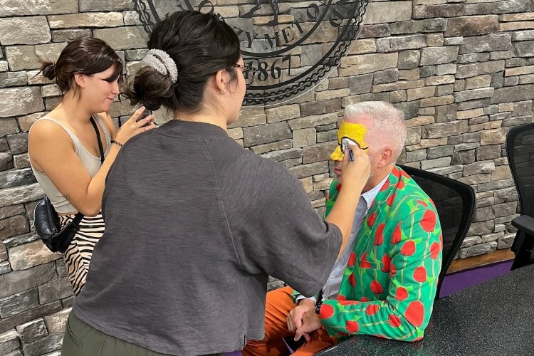 Holland Mayor Nathan Bocks gets his face painted for a TikTok video.
