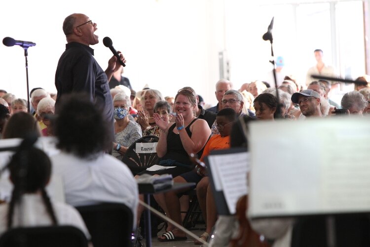 Members of the audience react to Byron Stripling's performance with the Holland Symphony Orchestra while attending the "Pops at the Pier" concert at Eldean Shipyard in Macatawa, Michigan, June 16, 2022.