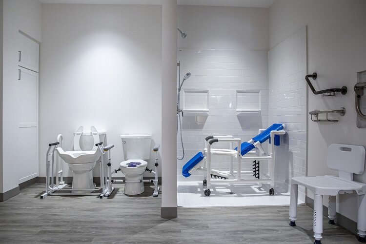 Alongside the test kitchen are the bathrooms. Shower options include a large shower stall and roll-in shower chair, as well as a standard bath and a variety of shower bench chair configurations.