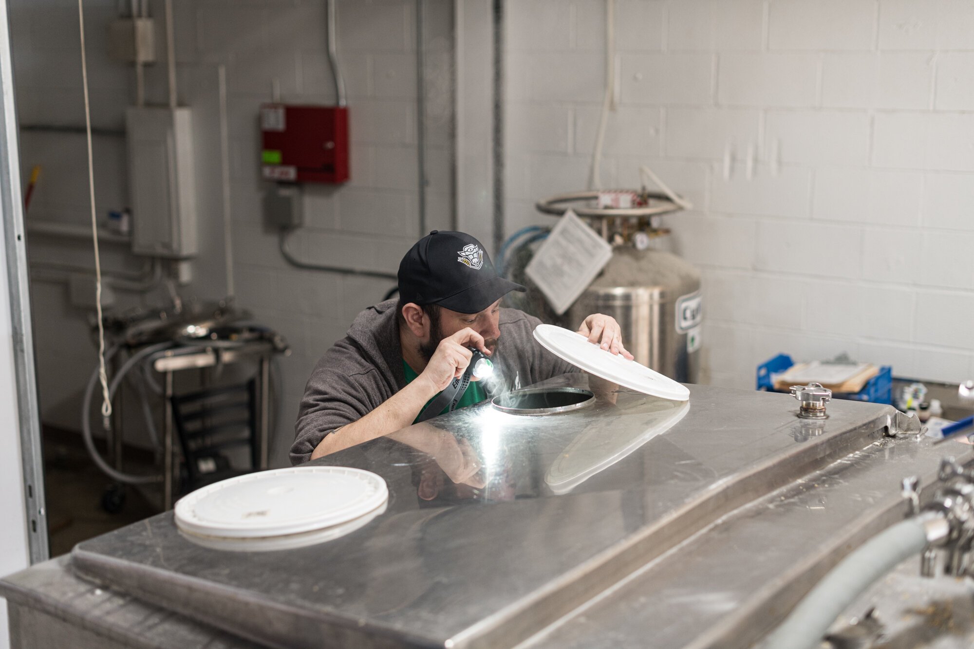 Jim Goodburn, brewer and business partner, checks a tank.