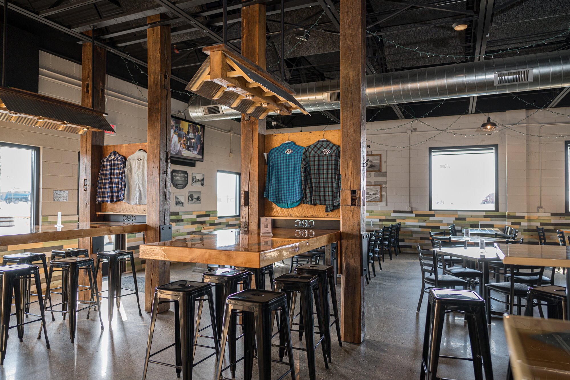The tables were designed for the brewery. Some contain the logos of local companies.