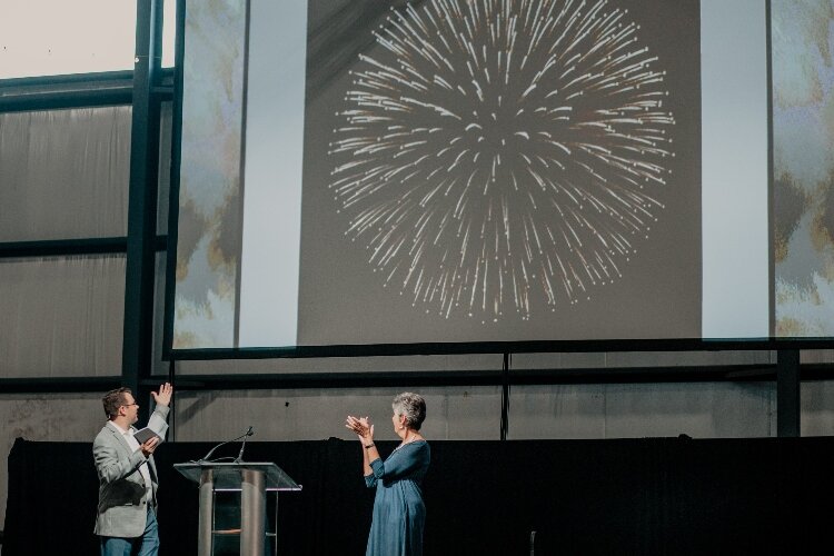 CFHZ President Mike Goorhouse and his predecessor Janet DeYoung announce the foundation's $100 million asset milestone.