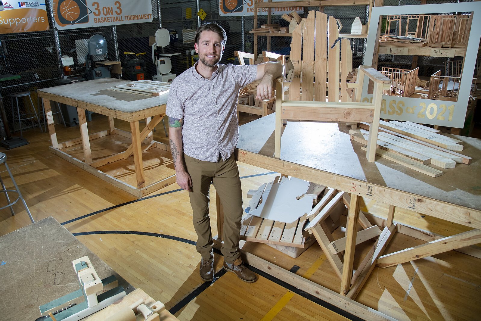 Kyle Jelens showing off his student's work inside of the woodshop.