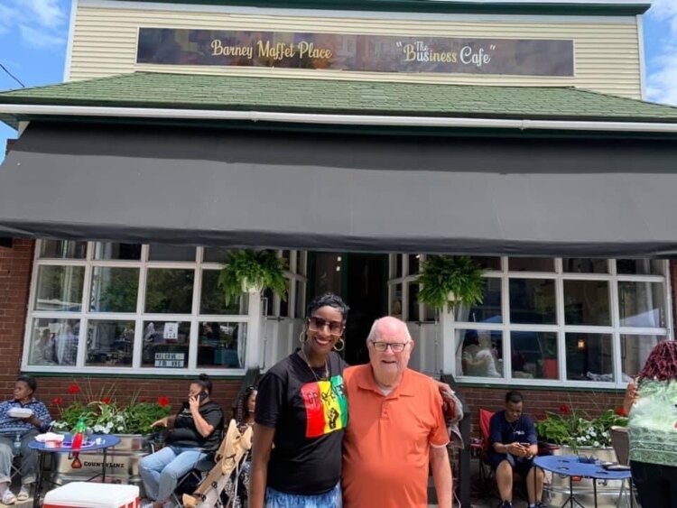 Kaja Thornton Hunter with William Boelkins in front of the Barney Maffett's "The Us Cafe."