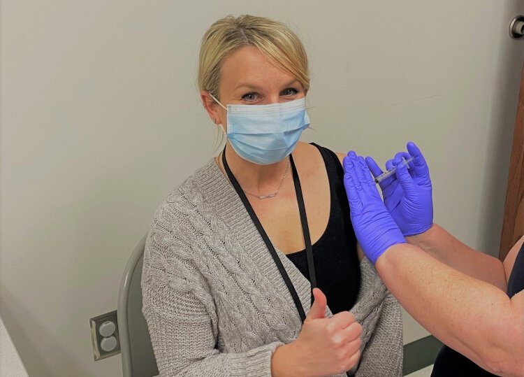 Erin Radke, public health nurse for the Allegan County Health Department receives her first dose of the COVID-19 vaccine.