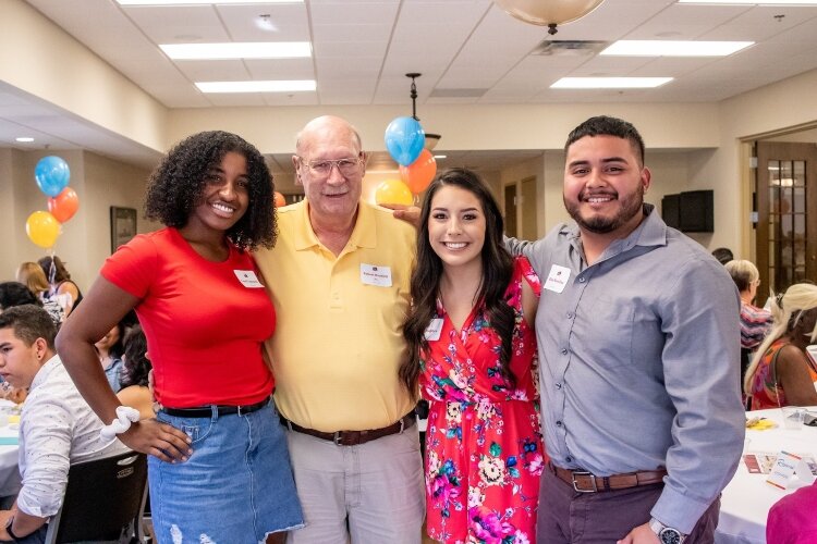 Three recent high school scholarship winners with a CFHZ donor.
