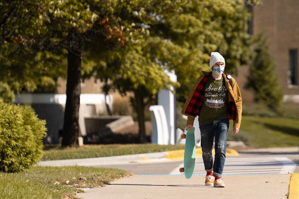 Student wears a mask on campus.