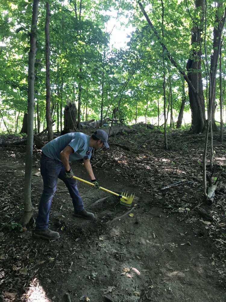 A DISHER employee volunteers his time, working on a trail.