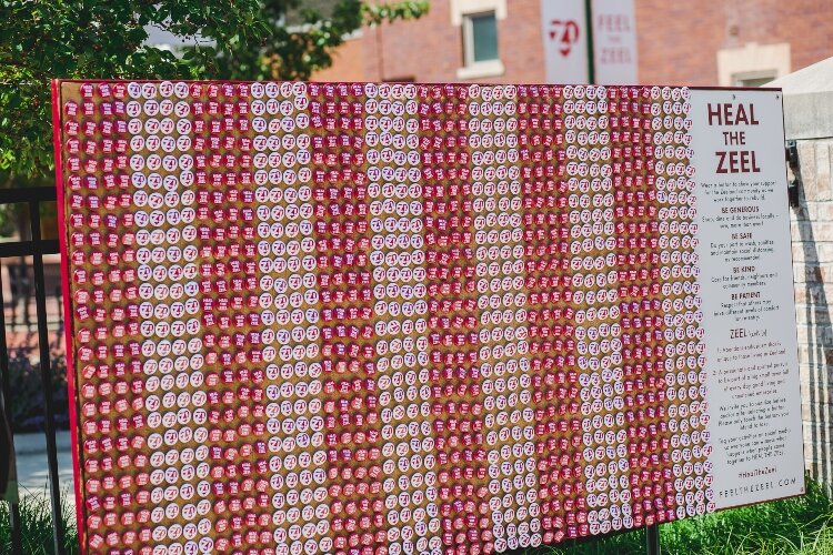 The interactive exhibit, located on the corner of Main Avenue and Elm Street, takes the shape of a wall made up of red and white campaign-style buttons.