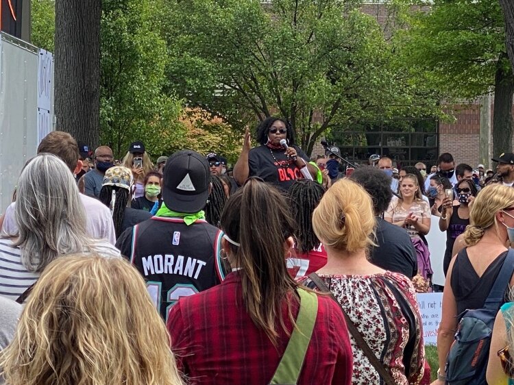 Shutaveya Ward speaks to the crowd during a rally before the march.