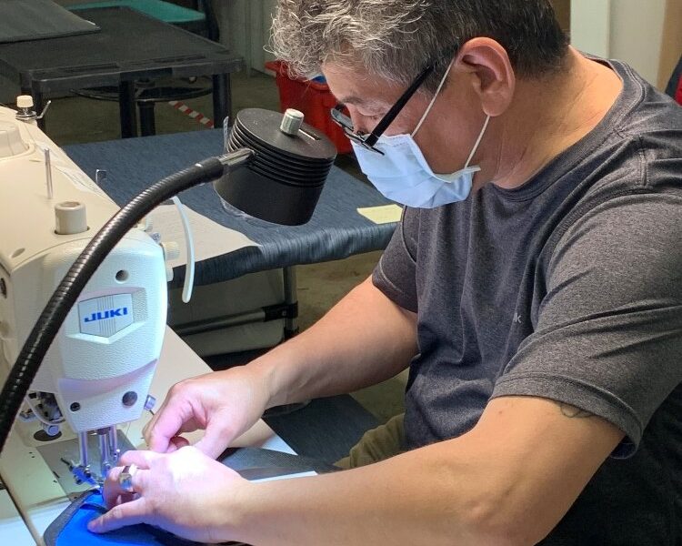 Ebrahim Mohammad Eshaq sews masks.