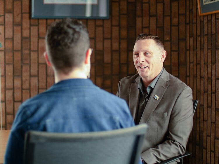 Patrick Moran talks with Amanda Telgenhof, Allegan United Way Area Director, in his office. Photo by Matthew J. Huizenga
