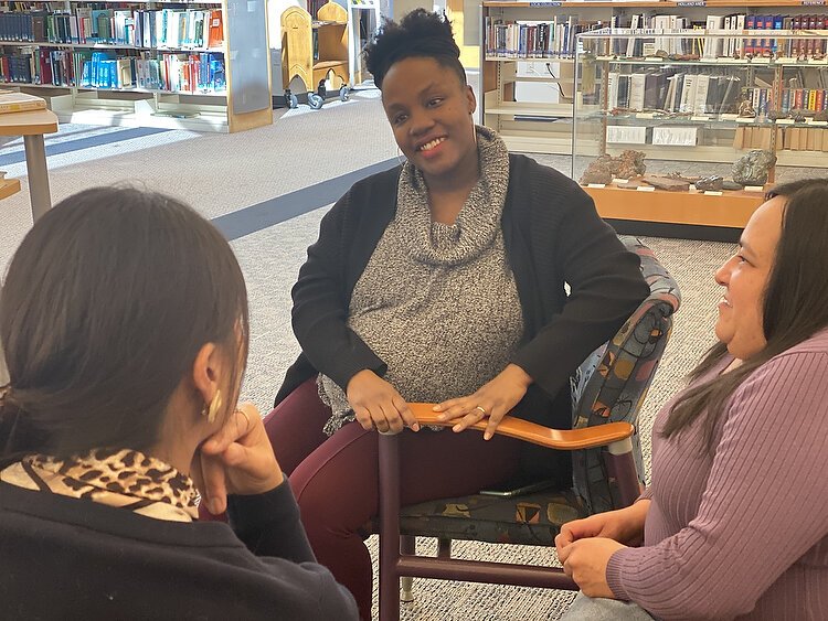 Women of Color GIVE cofounder Yah-Hanna Jenkins Leys talks with the group's cofounders, Lucia Rios and Robyn Afrik. Photo by Shandra Martinez