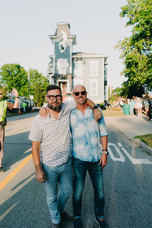 Robert Lopez and Patrick Roggenbau stand in front of the Lilley Mansion.