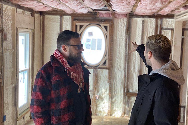 Robert Lopez and photographer Chase Loreto stand in a suite in the Lilley Mansion that is being completed.
