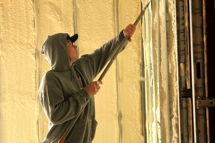 A worker adds installation in a new mixed-income housing project being built in Holland.