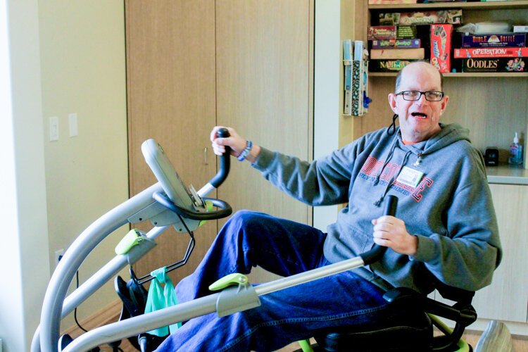 Richard Dornbos rides a stationary bicycle as part of his physical therapy at the LifeCircles PACE Hub in Holland Township.