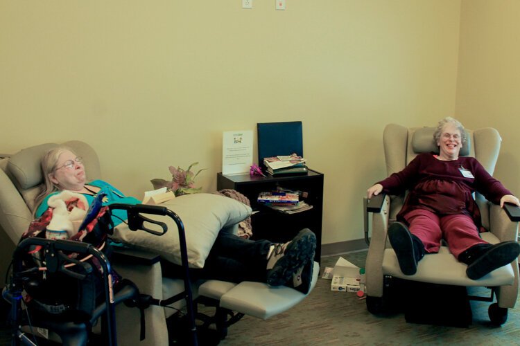Jacqueline Eding (left) and Lisa Chittenden chat and relax at the LifeCircles PACE Hub in Holland Township.