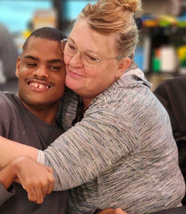Darla Maltby giving a hug to longtime student, DJ Betzner.