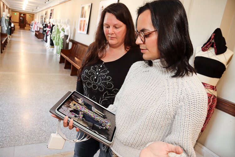 Rogellio Villarreal shares some of her designs with Sarah Pham, who is also a Fashion Studies student at KCAD.