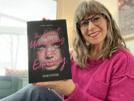 Local author Melanie Hooyenga poses with a copy of her new novel "The Quiet Unraveling of Eve Ellaway.”