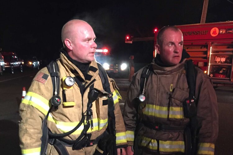 Scott Heerema (left) stands with another Park Township fire fighter.