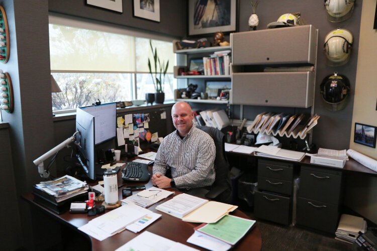 Gentex Director of Facilities Scott Heerema sits at his desk.