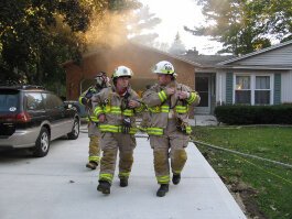 Scott Heerema (left) walks away from a house fire in Park Township.