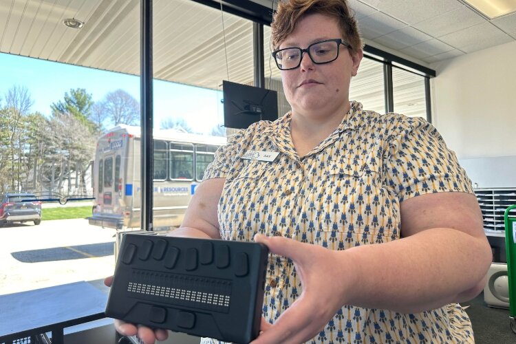 Librarian Sax Mahoney displays a digital player for the Talking Books program.
