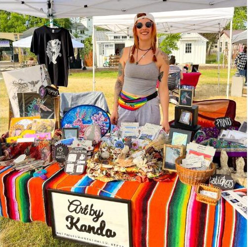 Board member and artist Kanda Parrot at the Art on the Green pop-up at the Artisan Market.