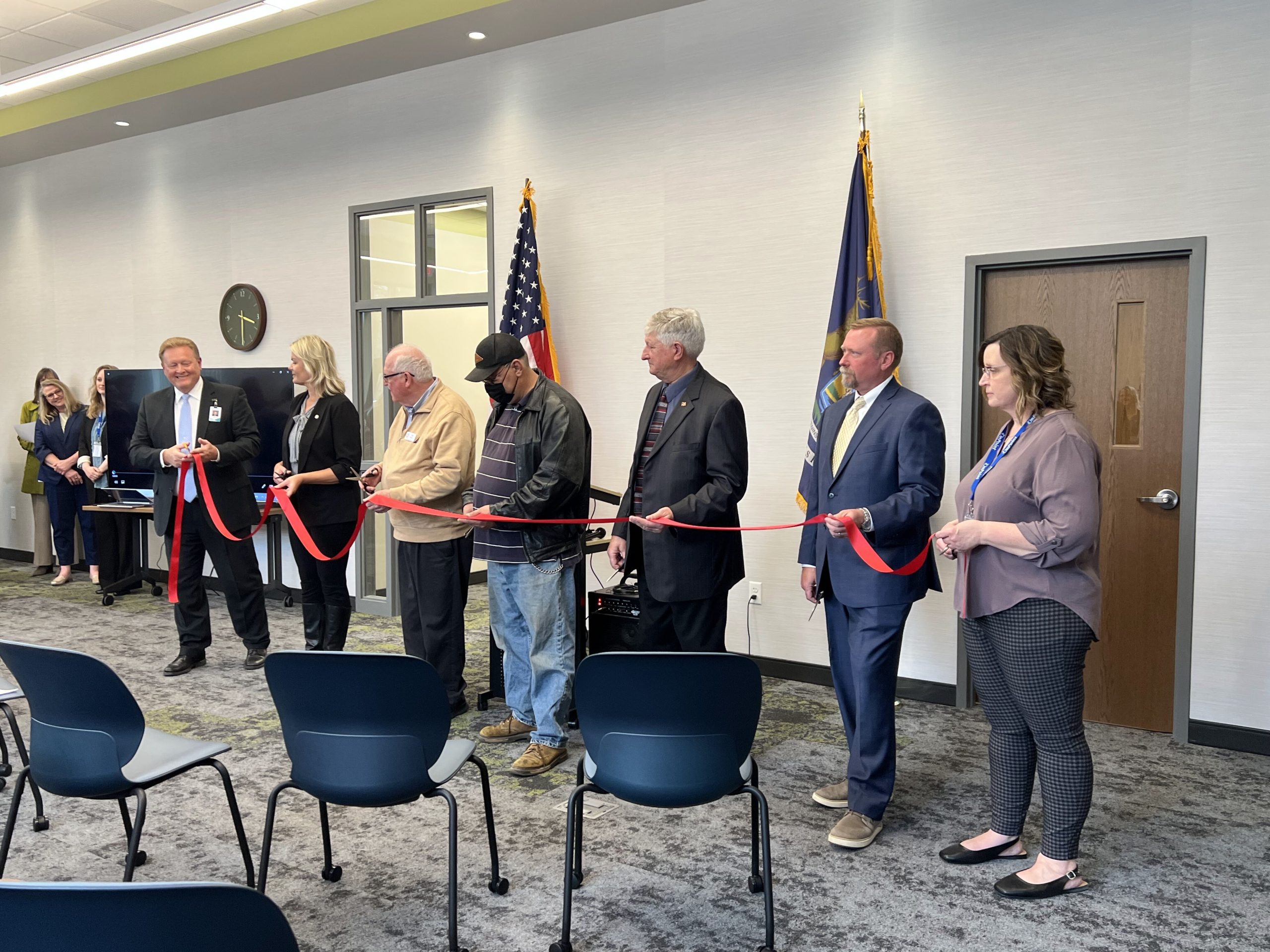 OnPoint staff and community leaders cut the ribbon to the organization's new facility.
