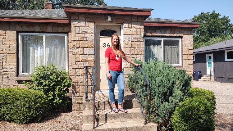 Christine Boatman stands in front of the house she bought with the help of the Holland Public Schools' Teachers Live Here grant program.