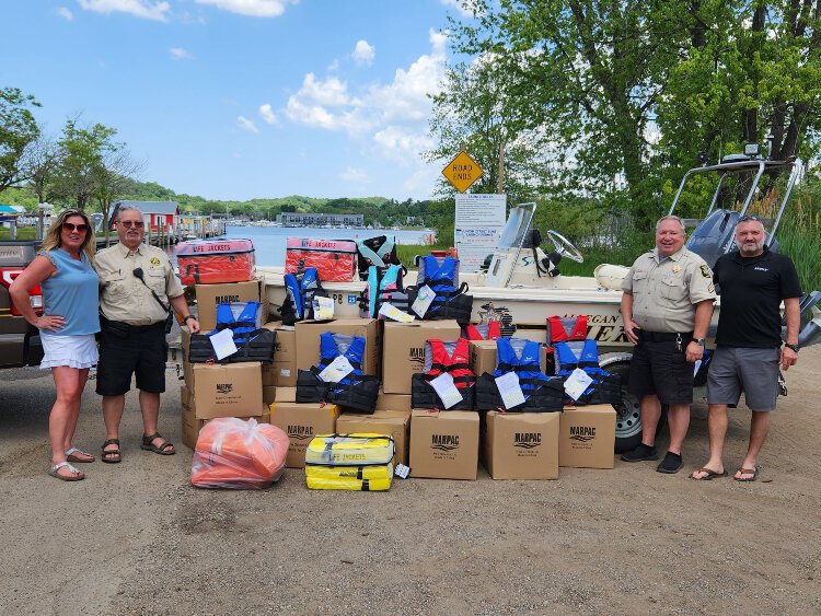 Pictured from left to right are Heather Upright-Solomon of ATA Title Group, Marine Deputy David Quarry, Marine Supervisor Todd Wagner and Kevin Schippa of Re/Max Realty of Saugatuck-Douglas.