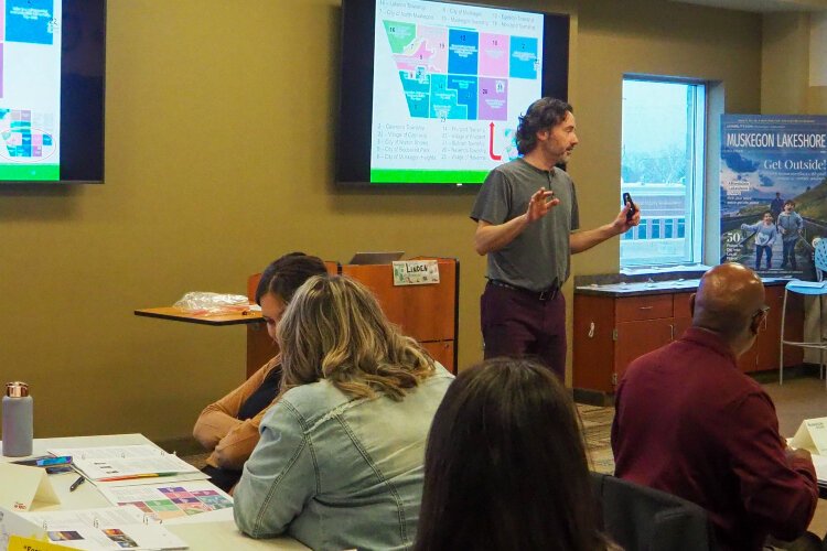 Linden Peterson, director of events for the Muskegon Lakeshore Chamber of Commerce, points out an area in Muskegon County during the STAR! training.