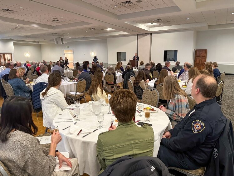 Tri-Cities community members listen to Michigan Supreme Court Justice Richard Bernstein speak.