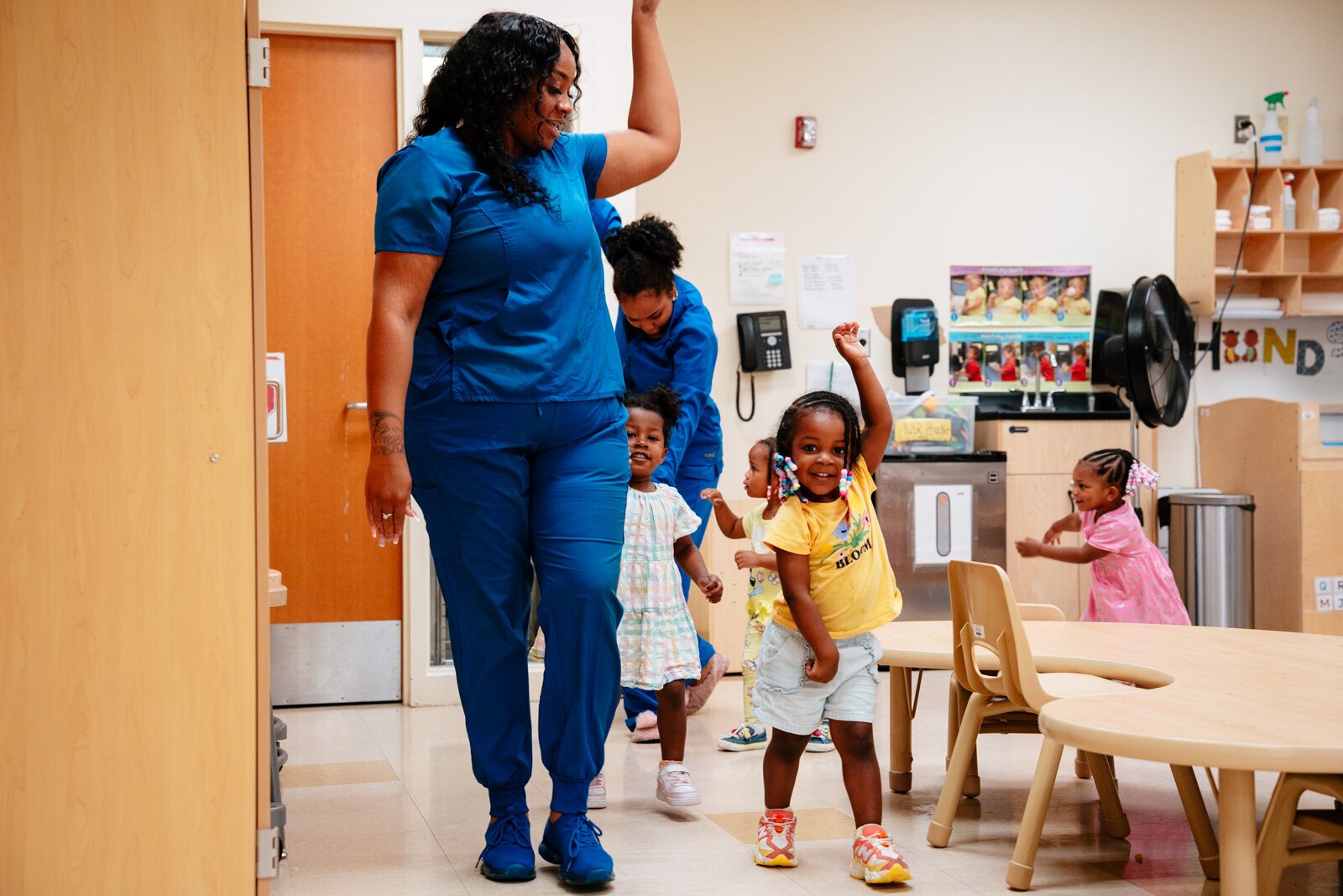 Teacher Shaquala Thorton leads a group of students around their classroom at New St. Paul Head Start Agency in Detroit.