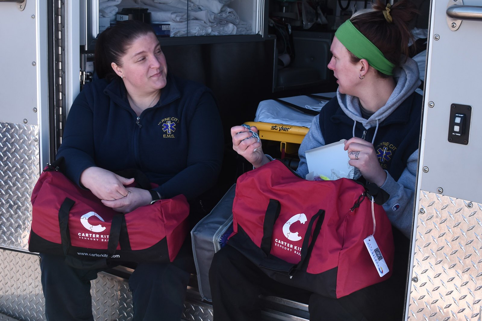 Paramedic and EMS director Brenda Willson, left, talks Carter Kits with EMT Jamie Dean, right
