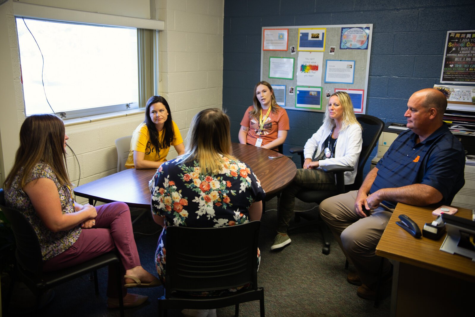 Airport Community Schools staff including Supt. John Krimmel (far right) confer with Family Medical Center staff including School Based Services Supervisor Meredith Gilliam (far left) and Behavioral Health Therapist Alexis Cavins (in orange shirt). 