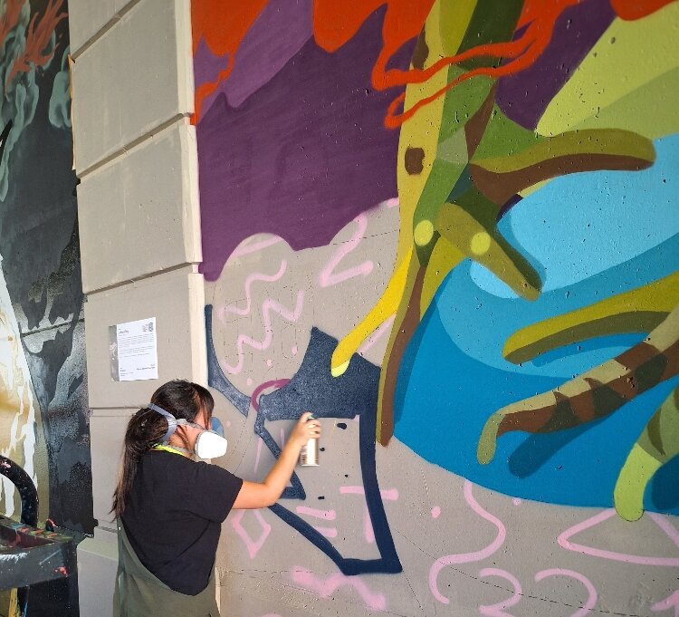 Guided by muralist Dustin Hunt (Muralmatics), Mikaila Doede created a 4-by-4-foot mural depicting an ecosystem and the relationship between two of its species.