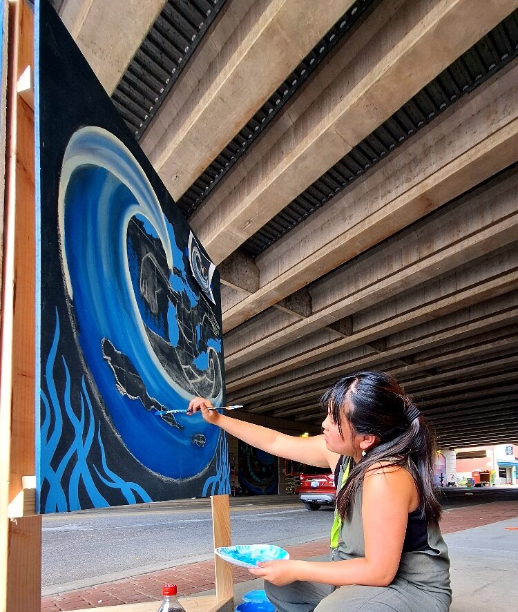 Mikaila Doede creating her art at the Pleasant Peninsula Mural Festival.