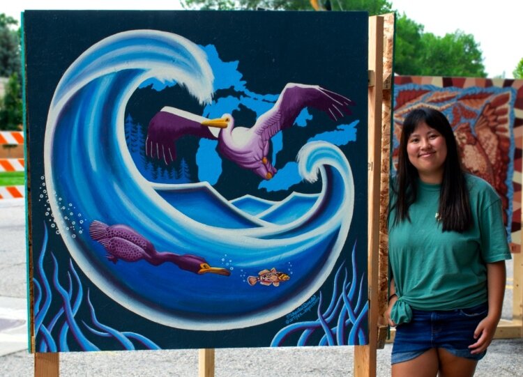 Mikaila Doede with her mural from the Pleasant Peninsula Mural Festival.