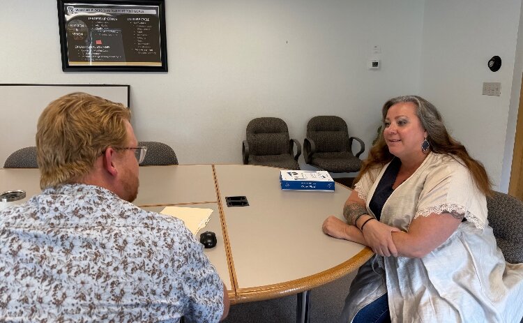 Wendy Dreese speaks with a 70 x 7 colleague. 